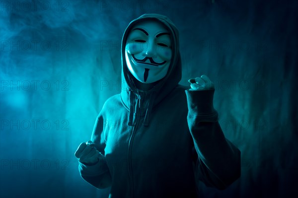 Hacker with anonymous mask with a symbol of fight