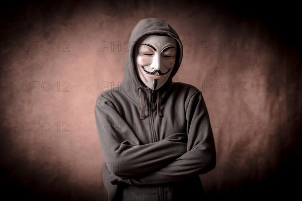 Man wearing anonymous mask with sweatshirt