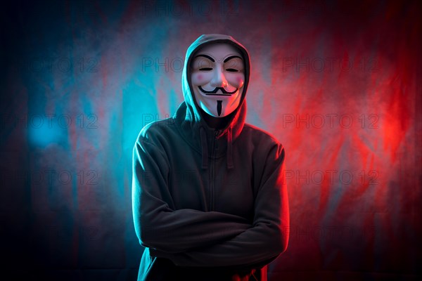 Hacker with anonymous mask with arms crossed