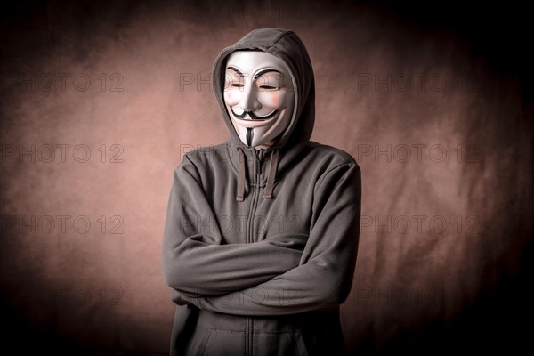 Man wearing anonymous mask with sweatshirt