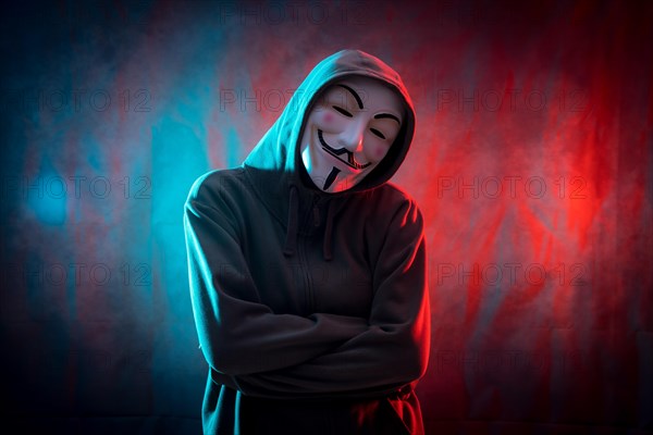 Hacker with anonymous mask with arms crossed