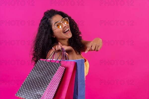 Curly-haired woman on a pink background