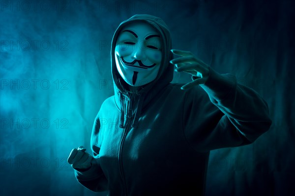 Hacker with anonymous mask with a symbol of fight