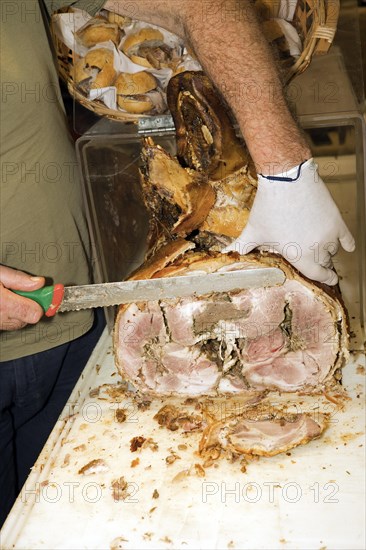 A man cuts a slice from a stuffed