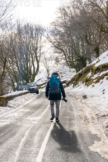 Photographer man taking a photo in the snow