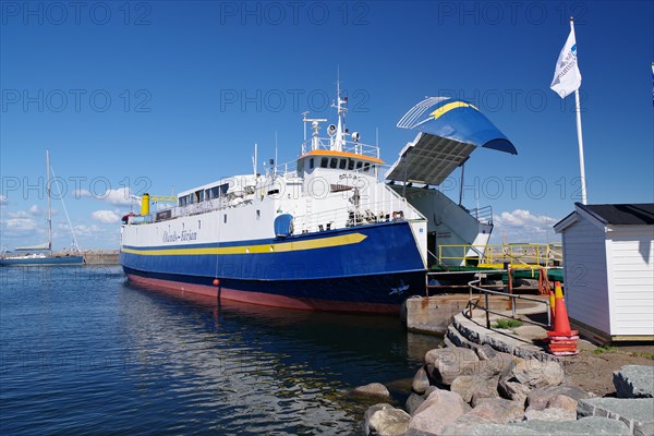 Small car ferry with open hatch in harbour