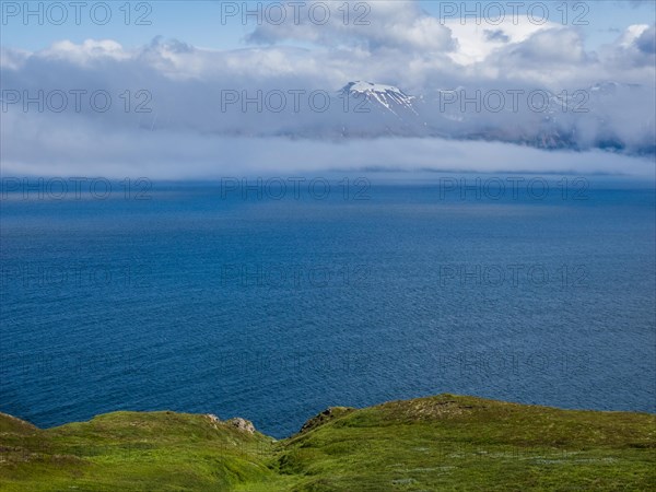 View over Eyjafoerour to the snow-capped mountains near Dalvik