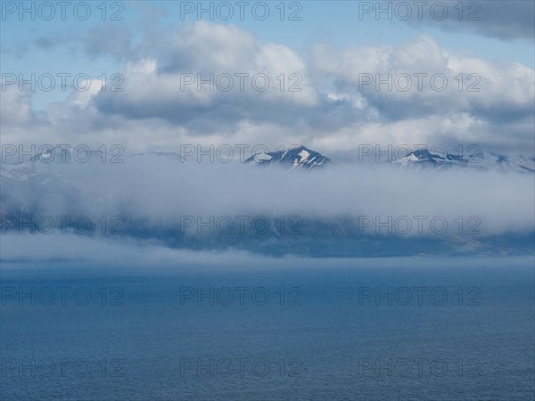 View over Eyjafoerour to the snow-capped mountains near Dalvik