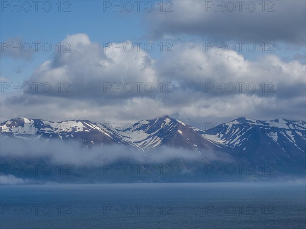 View over Eyjafoerour to the snow-capped mountains near Dalvik