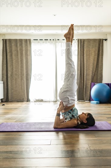 Side view of a woman practicing yoga