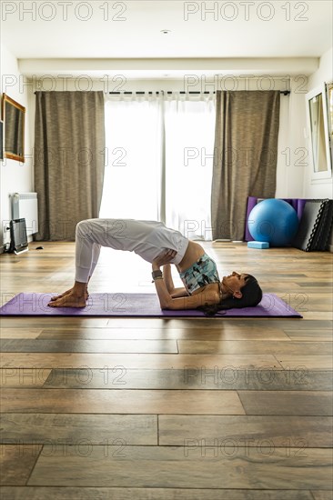 Side view of a woman practicing yoga