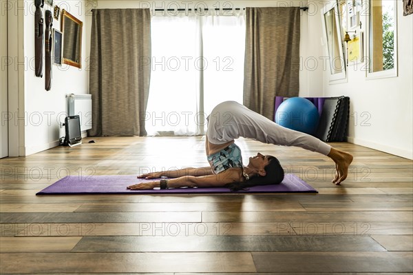 Side view of a woman practicing yoga