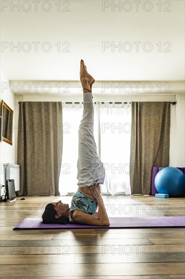 Side view of a woman practicing yoga