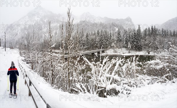 Snowshoe hiker in winter landscape