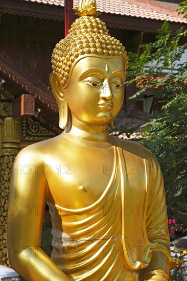 Golden Buddha figure in front of Wat Phra Bat Ming Muang