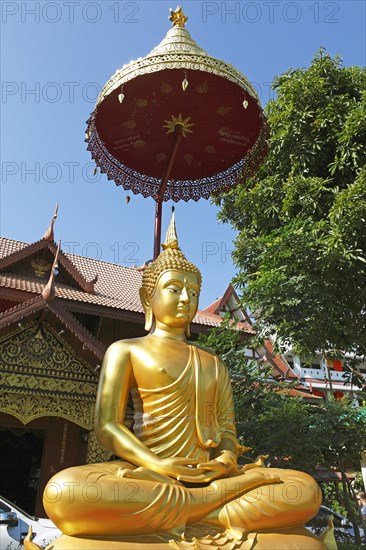 Golden Buddha figure in front of Wat Phra Bat Ming Muang