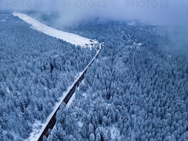 Road through the forest to the ski slope in the Black Forest with snow