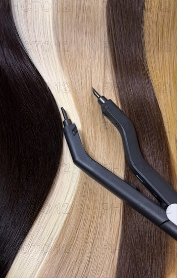 Strands of natural hair in different colors for extensions with tools