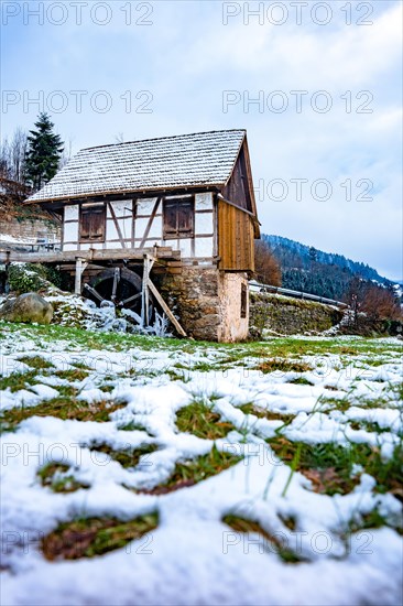 Water mill in snow and ice in winter