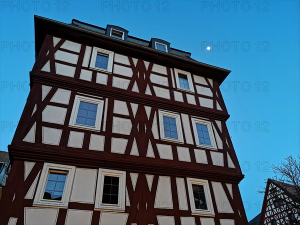 Half-timbered house photographed against the evening sky