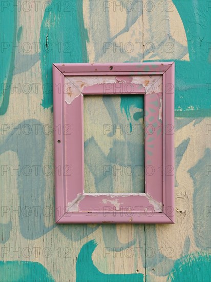 Weathered picture frame on a wooden wall