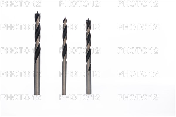 Drill bits of different sizes isolated on white background and copy-space