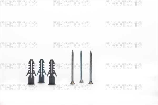 Screws and dowels isolated on white background with copy-space