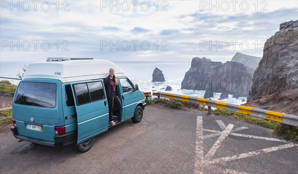 Young woman looking out of a Vw bus