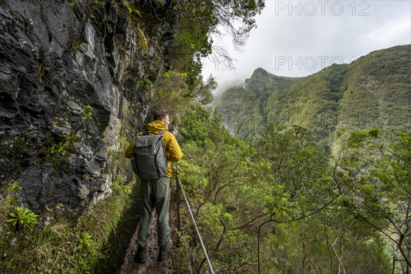 Hikers on a narrow path along a levada