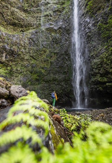 Hiker at the Caldeirao Verde waterfall on PR9 Levada do Caldeirao Verde