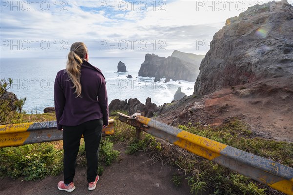 Young woman looking out to sea