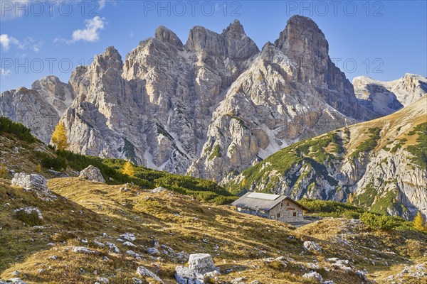Alpine hut with mountain panorama in autumn
