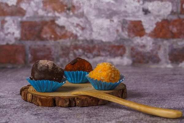 Truffles of different flavors on a wooden disk