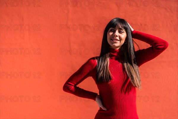 Posed brunette girl smiling in a dress in spring