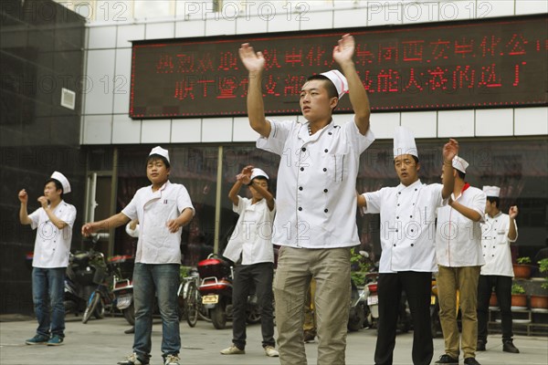 Chinese hotel employees doing morning exercises