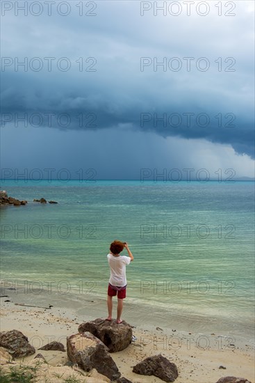 Young man standing on the beach