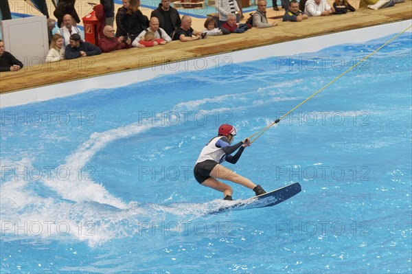 Wakeboarder glides over water