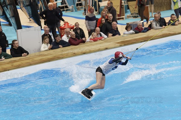 Wakeboarder glides over water