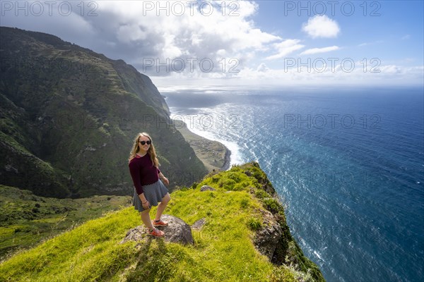 Young woman enjoying view of cliffs and sea