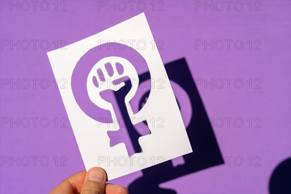 Symbol of the struggle of feminism on a purple background