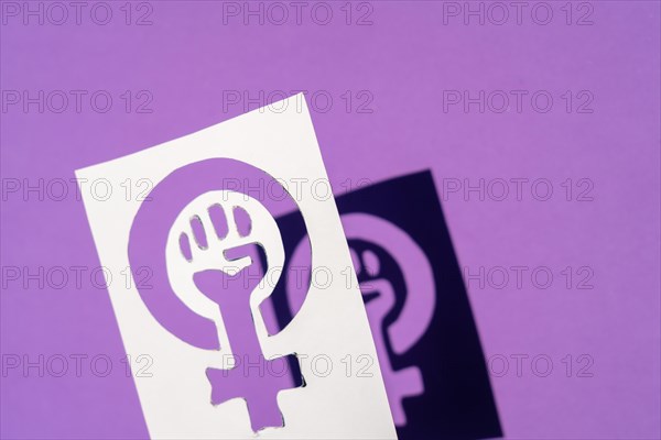 Symbol of the struggle of feminism on a purple background