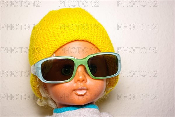 Cool doll with sunglasses and yellow knitted cap