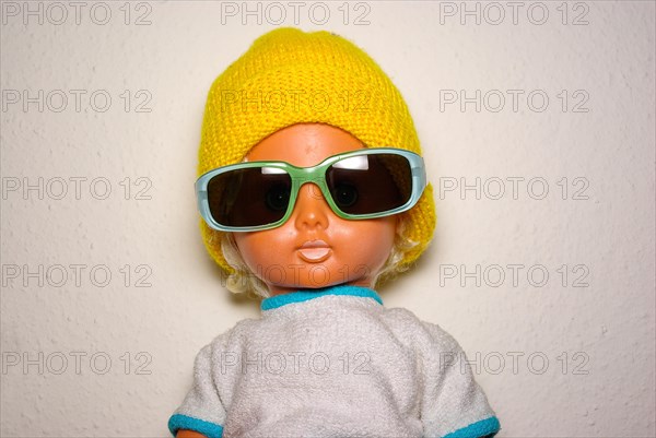 Cool doll with sunglasses and yellow knitted cap