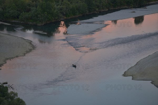 Fishing boat at the confluence of the rivers Buna and Drin with sunset