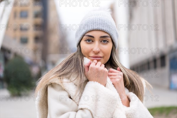 Winter portrait of a caucasian woman with a wool hat in the city