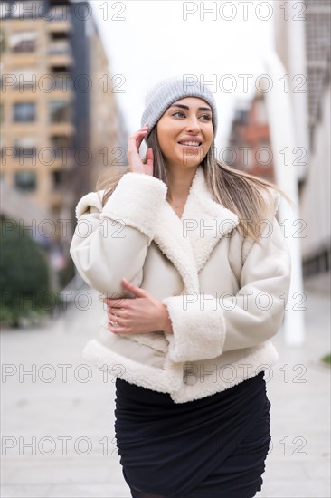 Winter portrait of a caucasian woman in a wool hat in the city