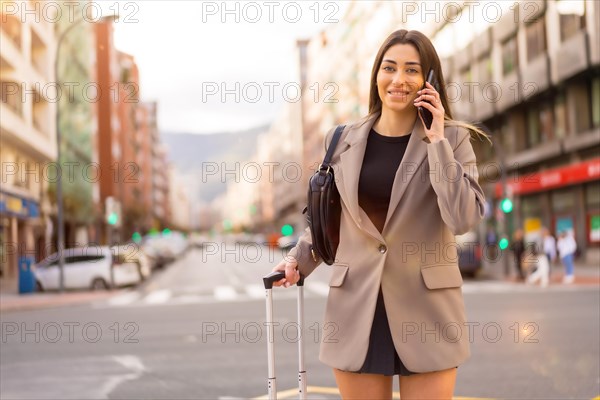 Tourist woman with suitcase in the city walking