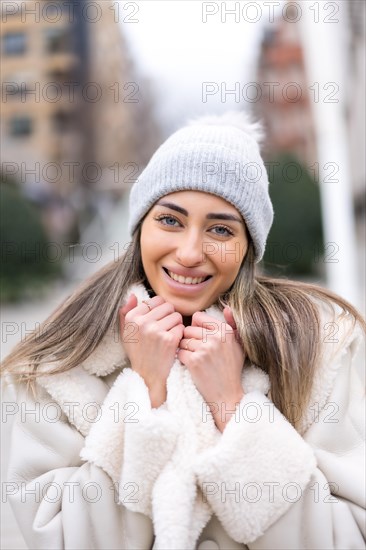 Winter portrait of a caucasian woman in a wool hat in the city