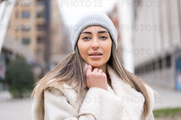 Winter portrait of a caucasian woman with a wool hat in the city