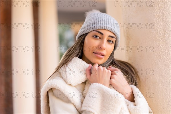 Caucasian woman with wool cap in a city park looking at camera